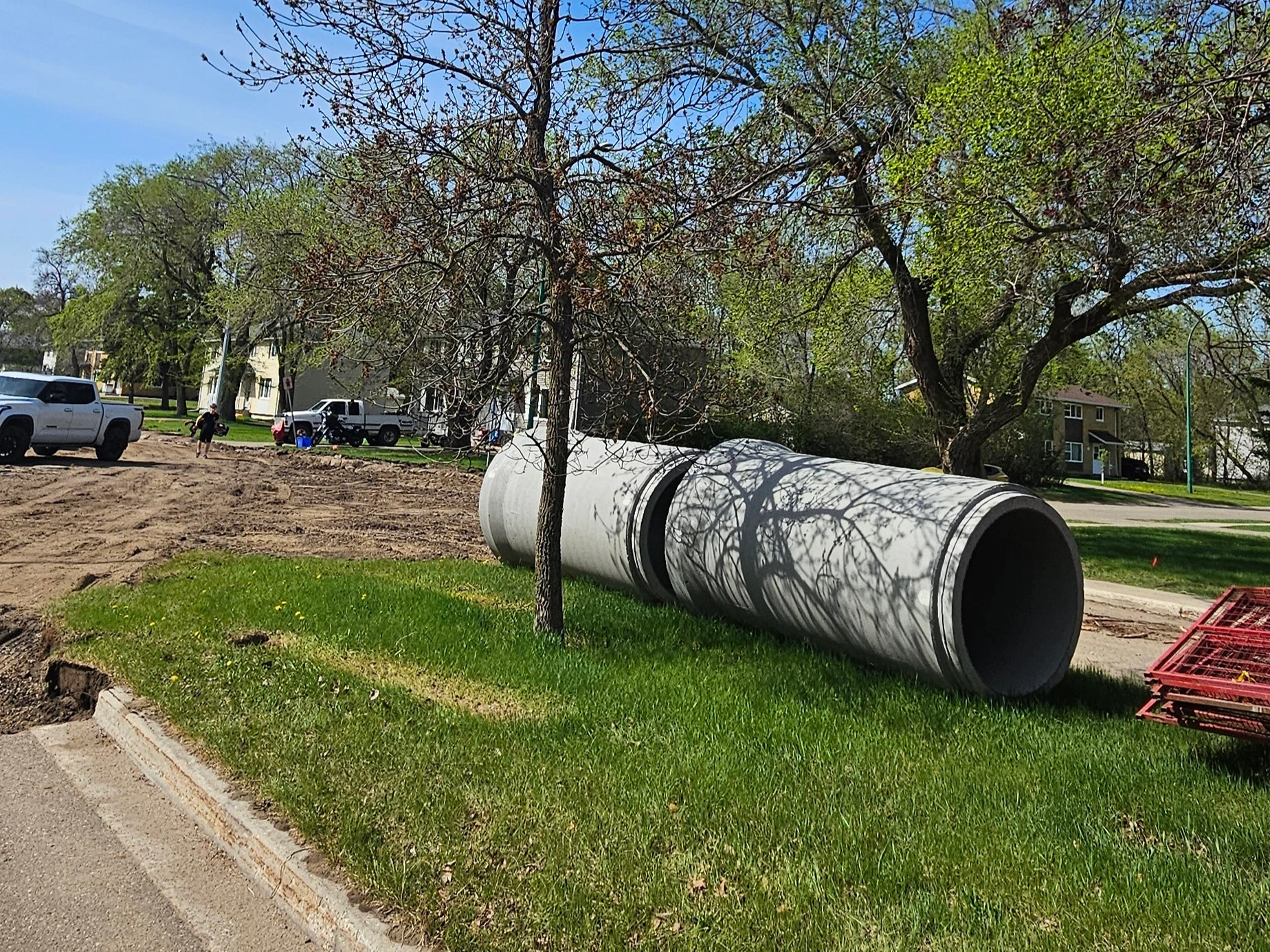Large concrete pipes for infrastructure upgrades on a residential street in Brandon, MB preparing for the CFB Shilo expansion