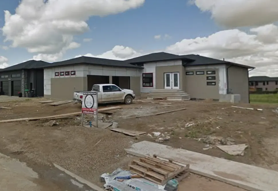 Photograph of new residential construction site near newly constructed house in Brandon, MB